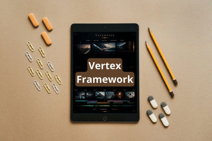 A tablet centered on a tan surface, surrounded by orange capsules, paper clips, yellow pencils, and white-and-gray capsules. The tablet screen shows the text 'Vertex Framework'.